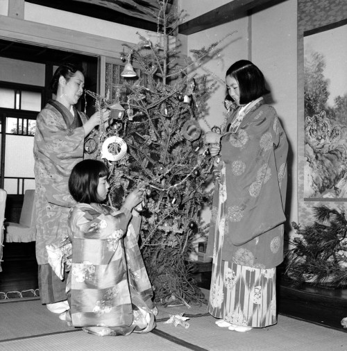 A kimono-clad family decorating their Christmas tree in Yokohama, Japan1950