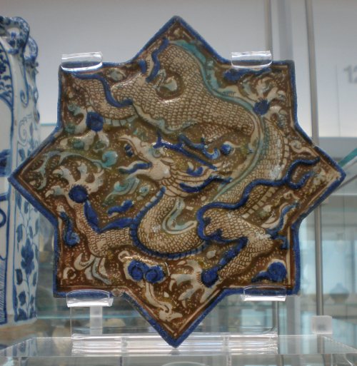 Wall tile (fritware) in the shape of an eight-pointed star, with a Chinese-style dragon.  From Takht