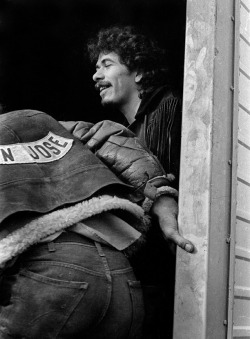 electricstateco:  A Hells Angel acts as security for Carlos Santanabackstage at The Altamont Speedway. December 6th, 1969. Photo by Robert Altman.