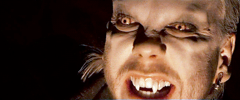 A GIF of numerous vampire boys showing their fangs
