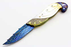 cerulean-satin:  nathansummers:  whiskey-wolf:  Ū,500.00 Titanium and Gold Lip Pearl Linerlock This knife is from Suchat’s New Diamond Edition. This liner locking folder features a carved Robert Calcinore Mosaic Damascus blade. The handle has carved