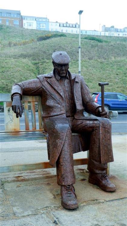 Freddie Gilroy sits on North Bay, Scarborough, North Yorkshire, England.A friend of the sculptor Ray