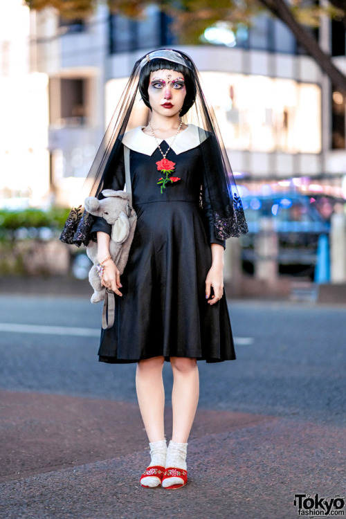 Japanese creator Millna on the street in Harajuku wearing a gothic look featuring doll makeup, a lac
