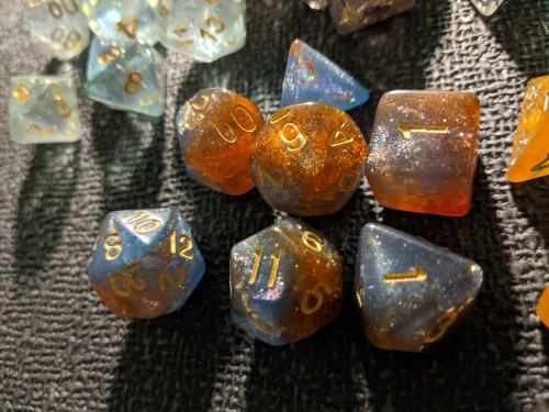 lichfucker:[image description: 4 photos of dice on a black, textured surface. the first is an overhe