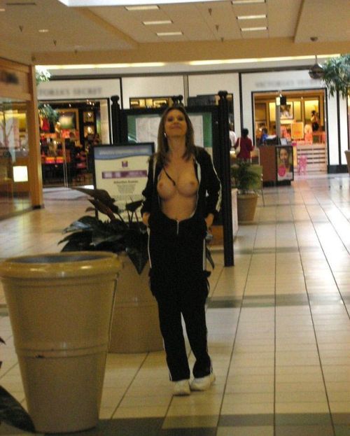 carelessinpublic: Showing her boobs and posing almost topless inside a shopping mall