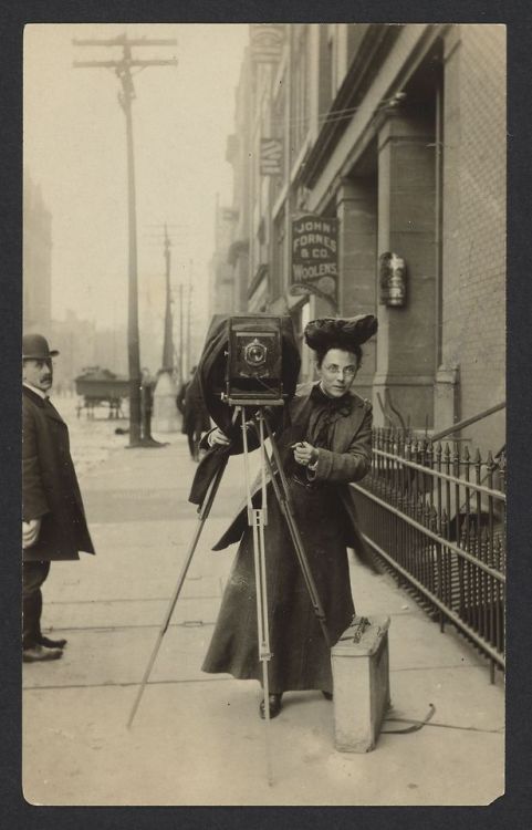 back-then: Portrait of Jessie Tarbox Beals standing on a city sidewalk with her camera c. 1901-1903 