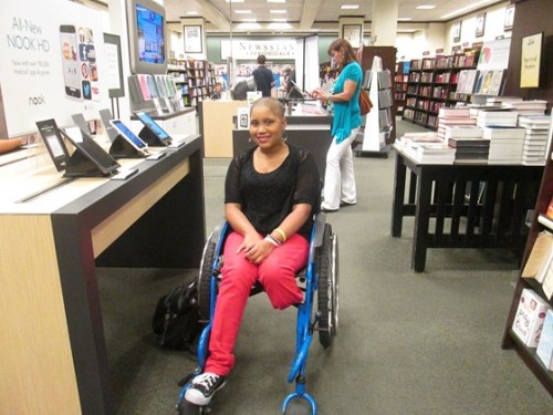 amputee girl in wheelchair wears converse shoe