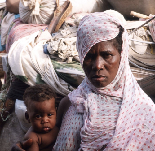 Fatma Mint Mamadou, a freed slave, holds her four month old baby Boubacar outside her shack June 15,