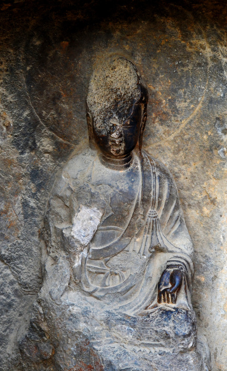One of the many partly defaced Buddhas at the Longmen Grottoes world heritage site, located in Luoyo
