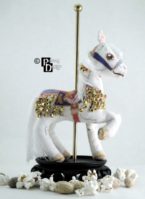 The bells, the bells! I sewed over 100 of them onto this 3d cross stitched carousel horse, but I thi