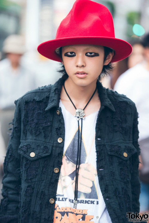 Japanese high school student Nashu on the street in Harajuku wearing a distressed denim jacket and m