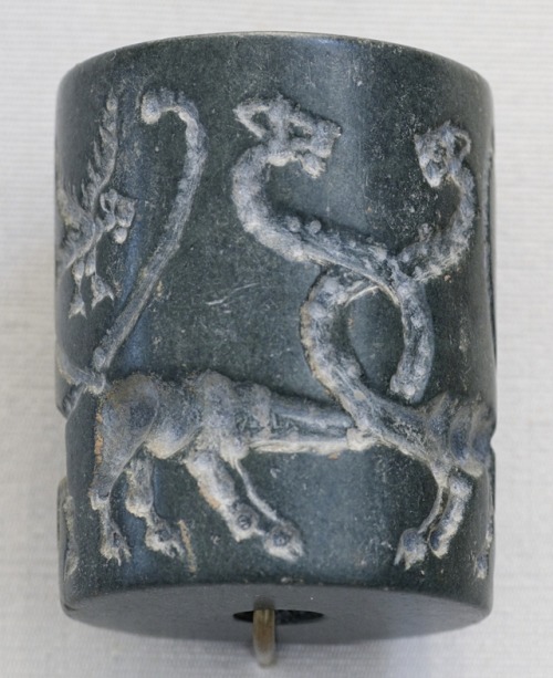 Ancient Mesopotamian jasper cylinder seal, depicting long-necked lions and lion-headed eagles.  Arti