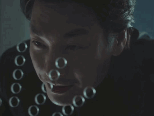 doyoung grinning, behind a transparent wall