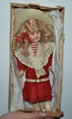 hazedolly: An antique bisque doll in her original box, with an all-original sailor outfit in near-perfect condition. The mohair wig looks immaculate and she even has her little hat and shoes (or perhaps just one shoe?). Ready for a day on the promenade,