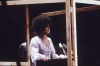 Porn rumman:Angela Davis speaking behind a four-sided photos