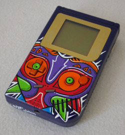 tinycartridge:  Majora’s Mask Game Boy ⊟Here’s another slick custom job from French artist Oskunk. This looks too nice to actually play with! Like, you can’t even leave this in the sun or do anything to let the vibrant colors on it fade. You