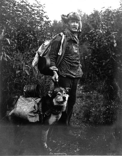 Gold prospector John Dubriel and his dog. Klondike Gold Rush, 1899.