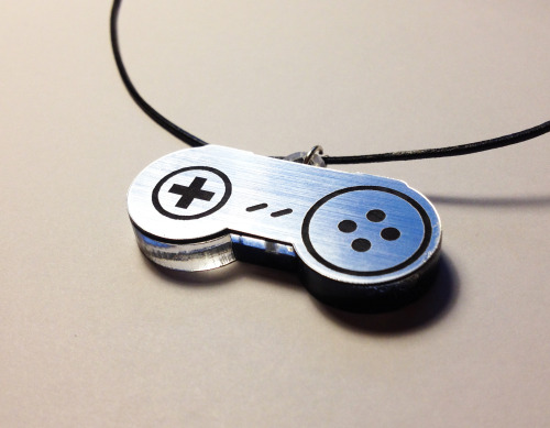 the-daily-robot:  New Laser-etched NES and SNES gamepad necklaces (in gold or silver!) available at The Daily Robot’s Etsy store!