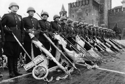 Red Army soldiers in Moscow hold captured Nazi banners during VE day celebrations, 1945.