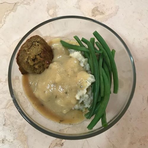 All home-cooked, oil-free vegan comfort food: mashed potatoes and gravy, lentil meatless ball, and f