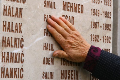 lilium-bosniacum: An elderly woman touches a memorial plaque dedicated to victims of the Bosnian gen