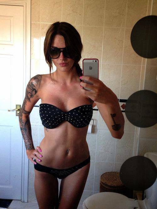 amazing handsome brunette with tattooed body in perverse lingerie on her big busty tits