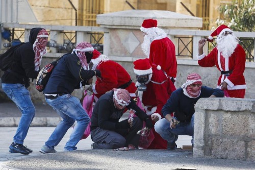 fuckyeahblackbloc: frompalestinewithlove: Merry Christmas from the Holy Land Palestinian protesters 