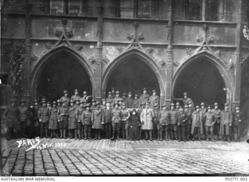 An informal group including Australian soldiers on leave standingoutside an old building in Paris (F