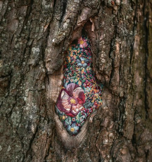 womansart:Diana Yevtukh often displays her embroidered textile art within nature, such as placing her pieces on trees 
