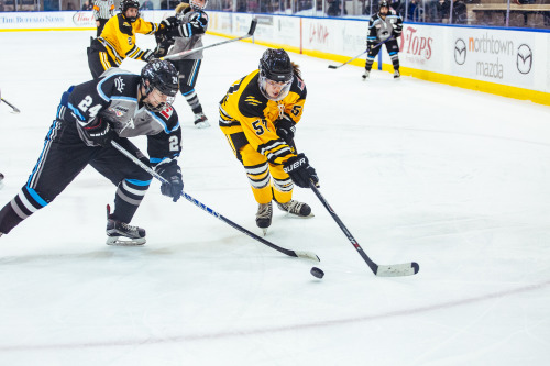 Harrison Browne (24) of the Buffalo Beauts and Meagan Mangene (57) of the Boston Pride battle for th