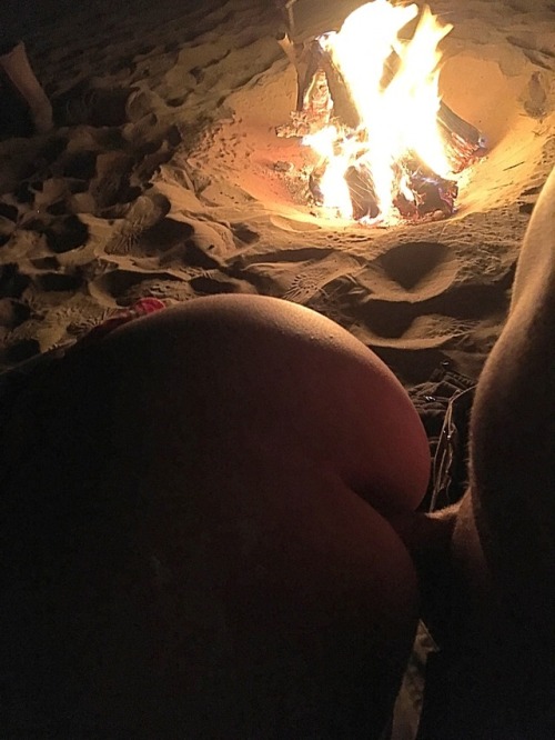 Doggy style sex by the camp fire.