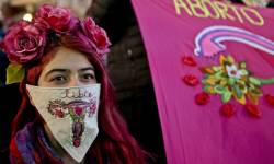 afrofeministe: A woman wearing a handkerchief embroidered with a uterus and the Spanish word for “free” participates in a pro-abortion march in Santiago, Chile. Photograph: Esteban Felix x AP 