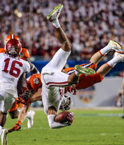 sportingnewsarchive:  PHOTO OF THE DAY:Oklahoma’s Sterling Shepard is upended by Clemson’s T.J. Green in the fourth quarter during the 2015 Capital One Orange Bowl at Sun Life Stadium on December 31, 2015 in Miami Gardens, Florida.  (Mike Ehrmann/Getty
