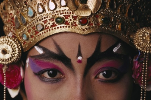 unrar:A close view of a face of a Balinese dancer in costume and makeup, Paul Chesley.