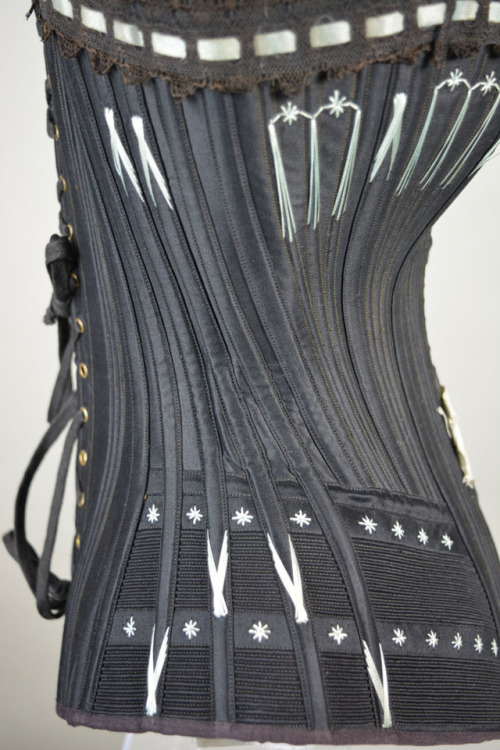 1890 Busk front corset typical of the beautifully designed styles of this period. Made with black la