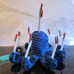 slothshark:  Born from a tiny brainstorm in the craft store during which I realized that Hanukkah has eight nights and an octopus has eight tentacles, here is menorahctopus, with a Hanukkah “candle” (made from pipe cleaners, in white and sparkly-red