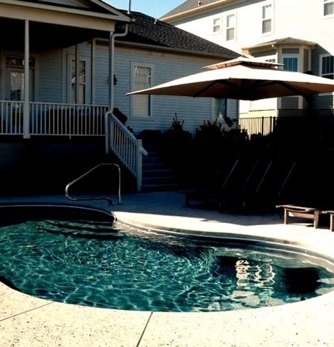 Lap - Modern PoolImage Of A Medium-sized Minimalist Lap Pool In A Concrete Backyard With A Kidney Shape.