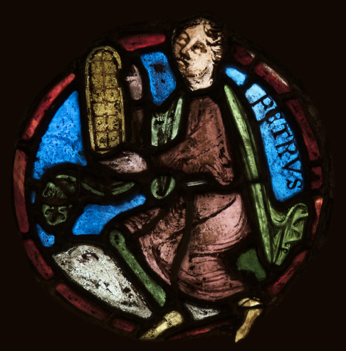 This 12th-century stained-glass panel from France shows a kneeling figure holding a model of the sta