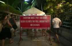 Thousands of people from around the world pack Haad Rin Beach, Koh Phangan, Thailand on August 22 2013 for the annual Full Moon Party, enjoying the cheap liquor and drugs in an all night affair. The full moon party started in late 1988 and has become