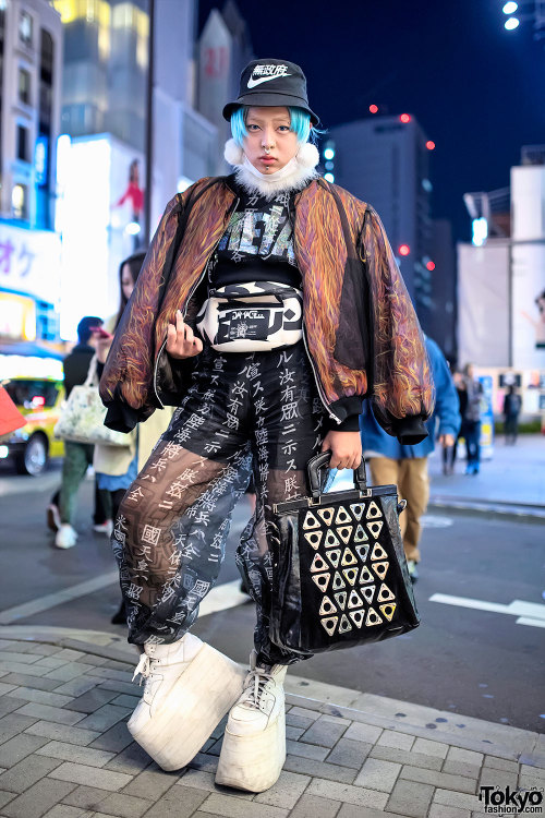 Shoshipoyo on the street in Harajuku wearing a Dog bomber over a Nikki Lipstick top with sheer kanji