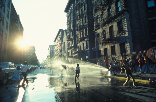 A fire hydrant refreshes youngsters on a hot day in Harlem, New York, 1977.Photograph by Leroy H. Wo