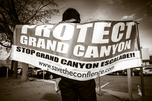 Roland Begay displays a protest sign in front of the Navajo Nation Council Chambers during the Grand