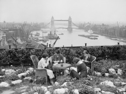 gnossienne:  Four women have lunch in the roof garden on Adelaide House, overlooking the River Thames and Tower Bridge, c. 1934 
