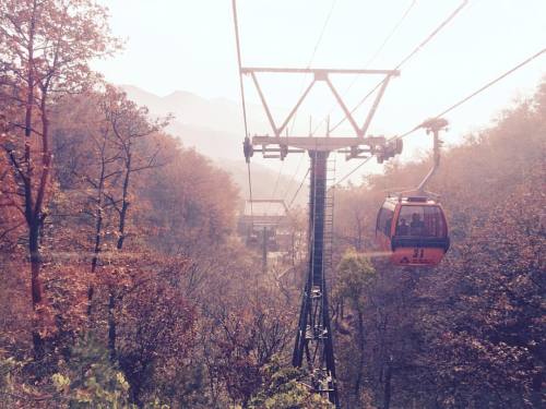 Autumn morn cable car:Sun has peaked over the mountaintops and washed it’s brightness over t