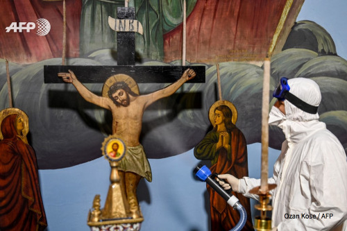 Worker with Istanbul’s Metropolitan Municipality disinfects the Panagia Altimermer Church, on March 