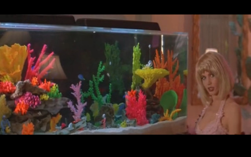 Nothing sexier than a fish tank. Geena Davis as Valerie Gail (post makeover) in Earth Girls Are Easy