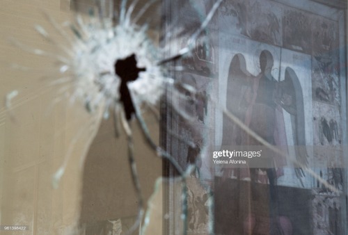 A bullet-damaged window pane in the Christian Orthodox church of Michael the Archangel in Grozny, Ch