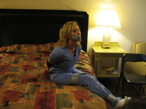 buckeyebound75:Having been left bound and gagged with duct tape by the infamous hotel bandit, Jamie tried desperately to free herself from the tape that bound her.  After an hour of struggling Jamie finally admitted defeat as she waited to be found by