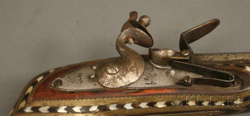 A pearly and brass decorated flintlock jezail originating from Afghanistan, lock is dated 1810.