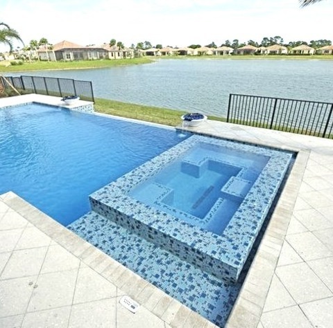 PoolExample Of A Mid-sized Backyard Stone And Rectangular Infinity Pool Design